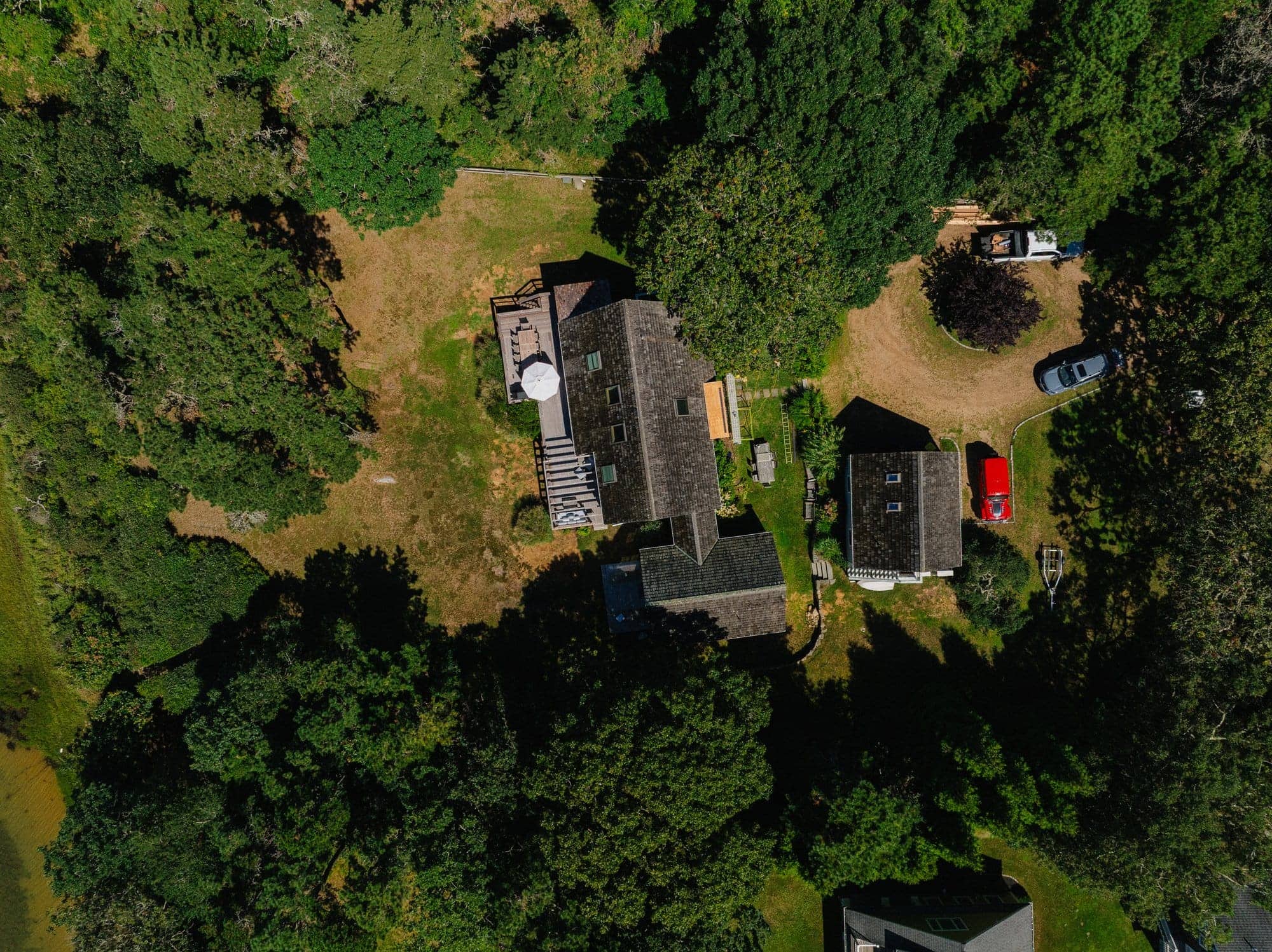 Caleb's Pond House — the shingled house, its deck and the pond, from above