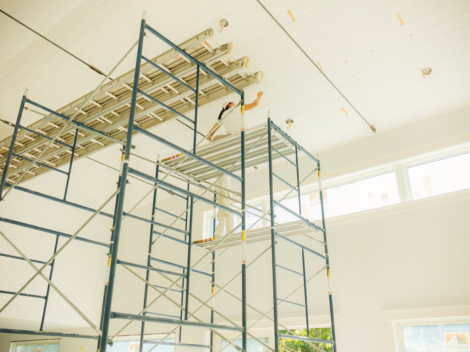 Pennywise Path — scaffold towers standing to the boarded ceiling of the double-height room
