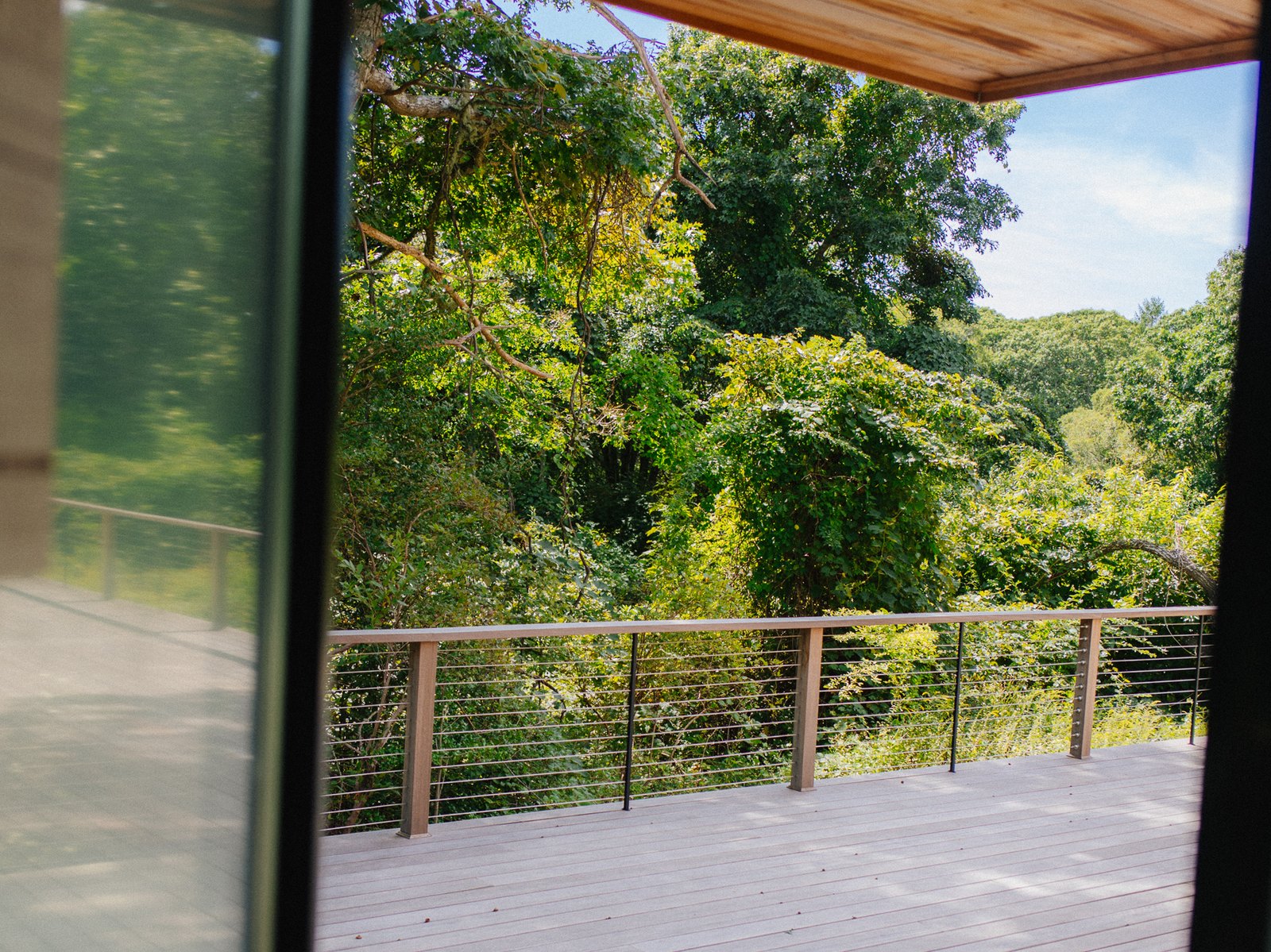 Pennywise Path — the covered end of the deck, looking out through the cable rail