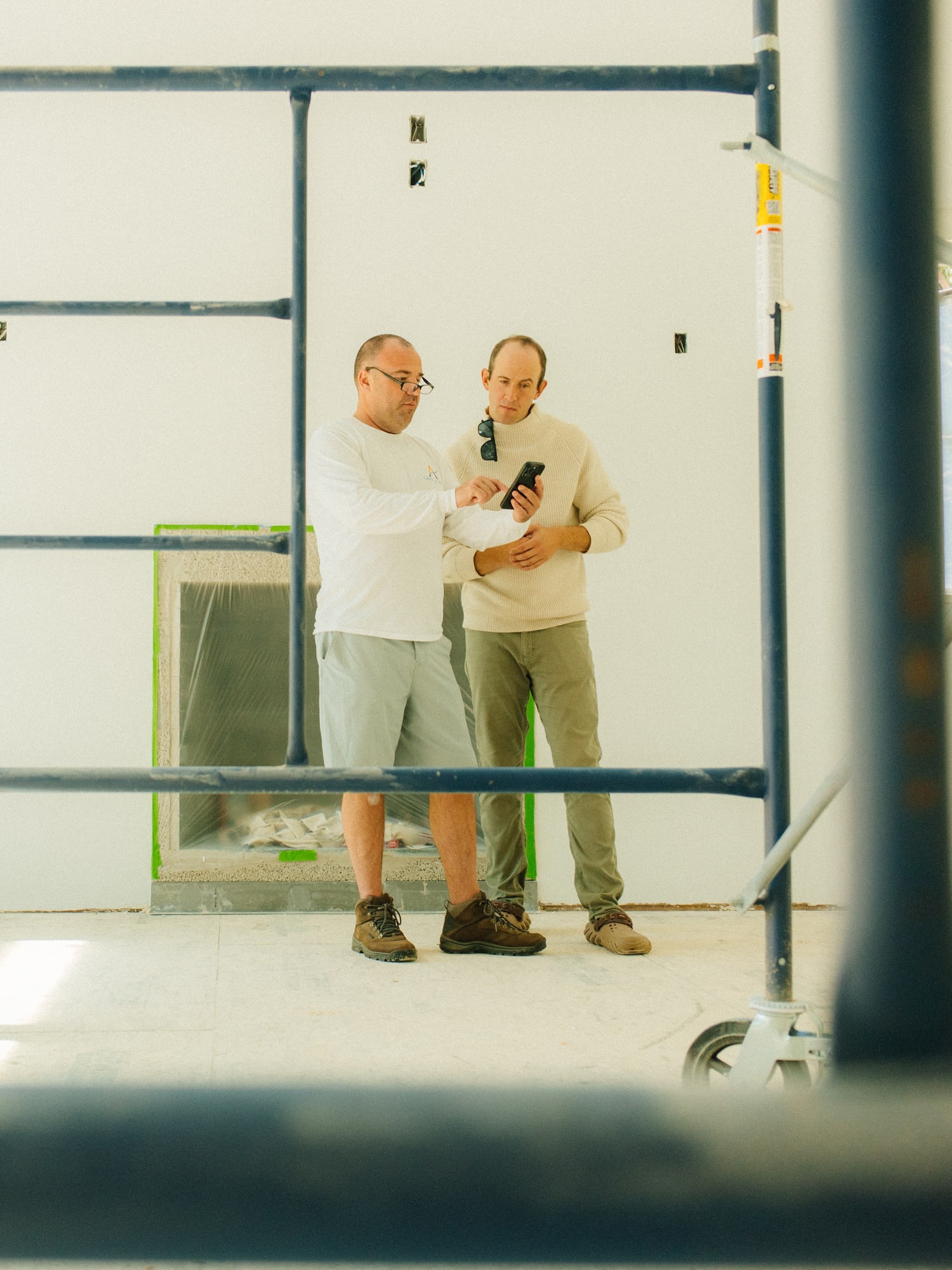 Zander Auerbach and the client at Pennywise Path, seen through the scaffolding in the unfinished room